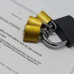 Closeup of padlocks laid out on document containing GDPR legislative text.